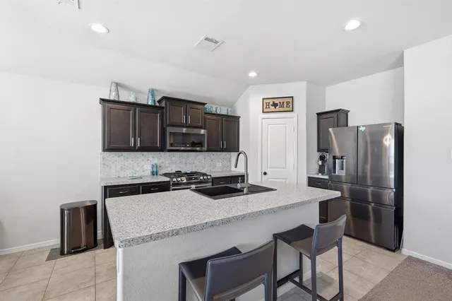a kitchen with stainless steel appliances a refrigerator and a stove