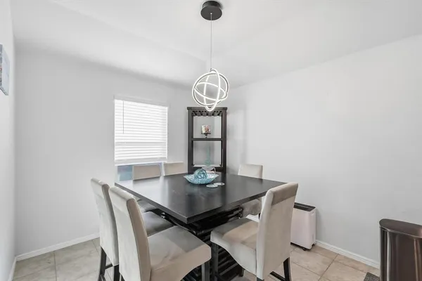 a view of a dining room with a table and chairs