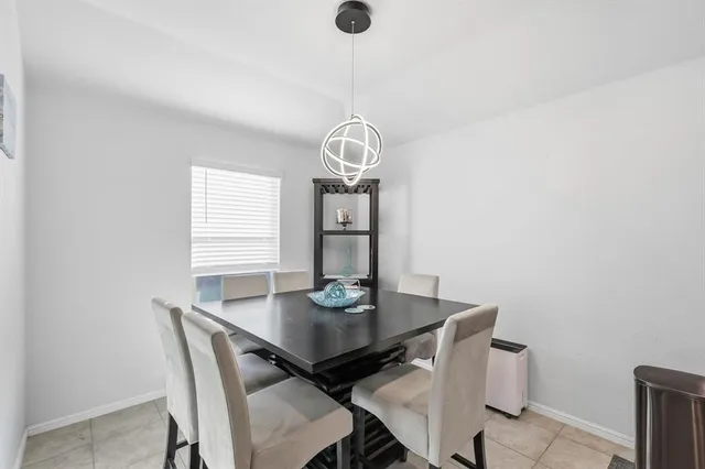 a view of a dining room with a table and chairs