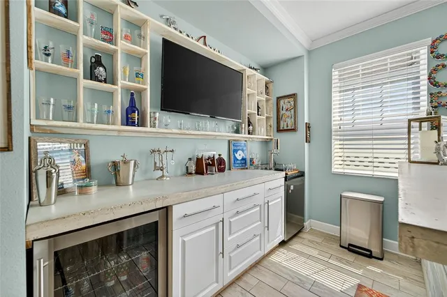 a living room with furniture and a dining table with kitchen view