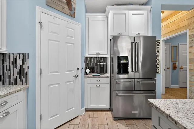 a white toilet sitting next to a white wall