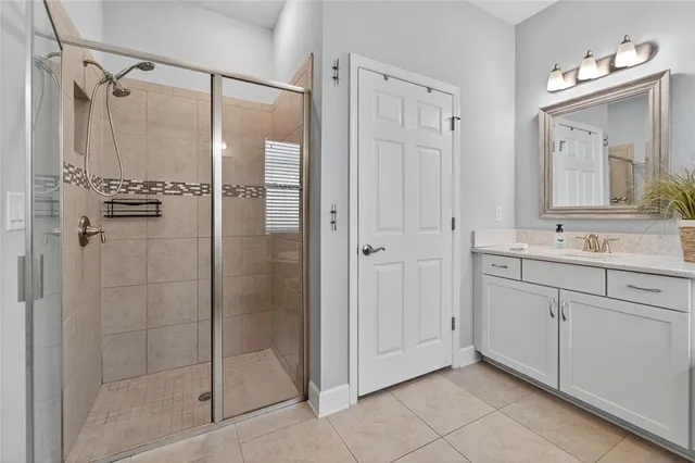a bathroom with a granite countertop sink vanity mirror and toilet