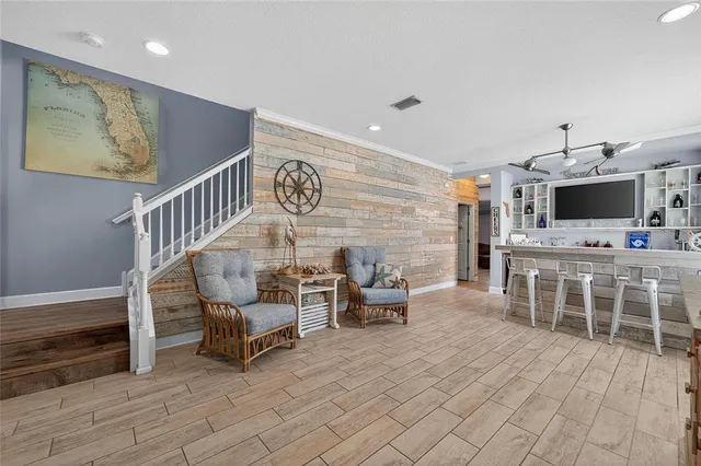 a large kitchen with cabinets wooden floor and stainless steel appliances