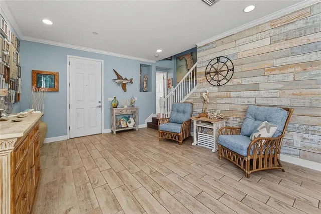 a living room with couches a dining table and chairs with wooden floor
