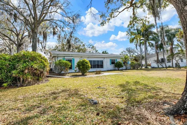 a front view of house with yard and green space