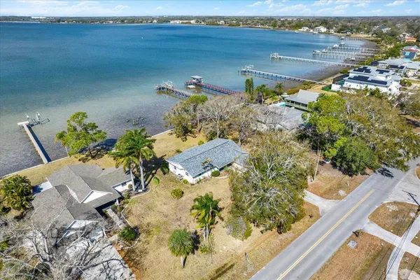 an aerial view of a house with a yard lake view and mountain view