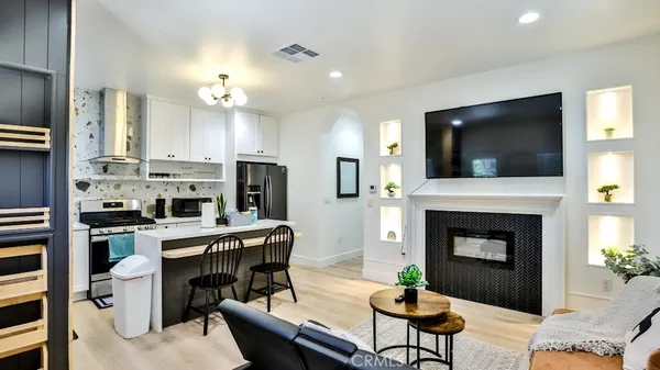 a living room with furniture a fireplace and a flat screen tv