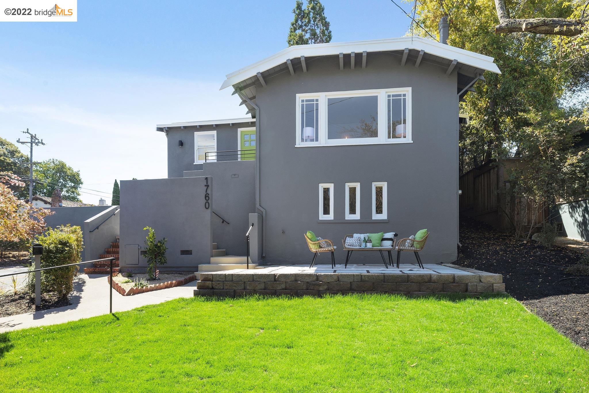 a front view of house with yard and outdoor seating