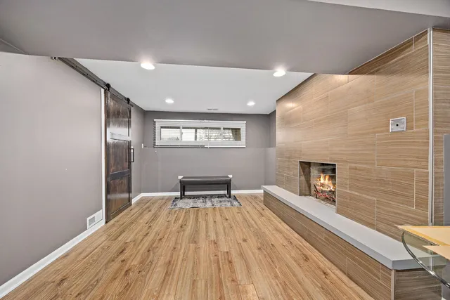 a view of wooden floor fire place and windows in a room