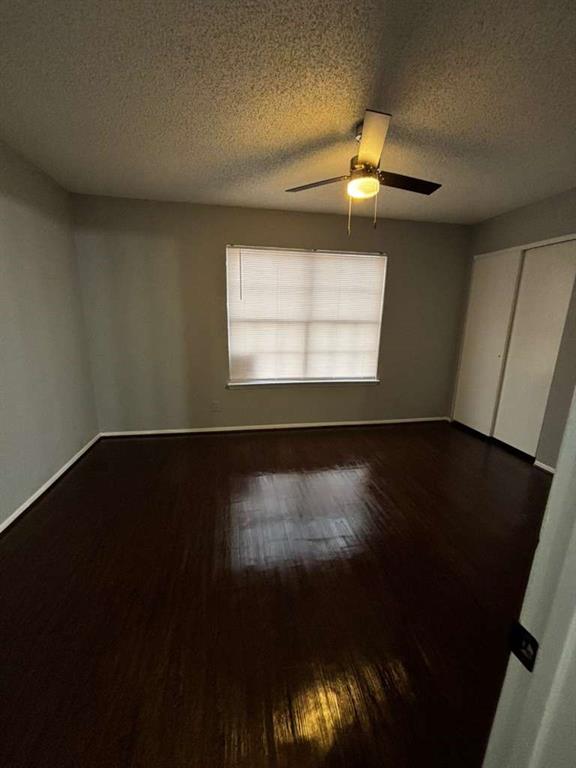 724 West Collins Street Denton, TX 76201 - Photo 4 of 12 wooden floor in an empty room with a window