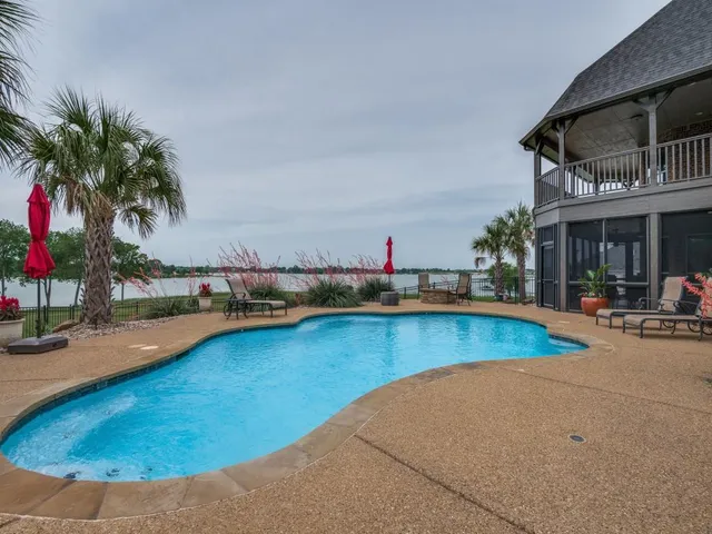 a view of swimming pool with outdoor seating and a potted plant