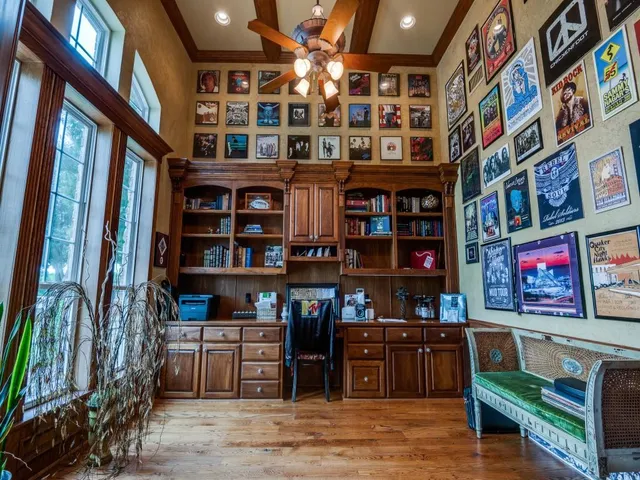 a room with lots of books and a large window