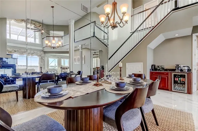 a view of a dining room with furniture a chandelier and wooden floor