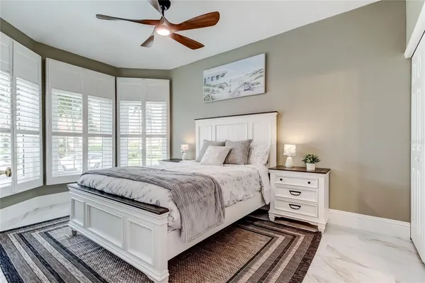 a spacious bedroom with a bed and window