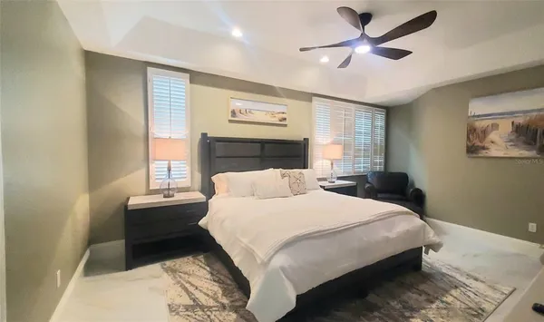 a bedroom with a large bed and a chandelier