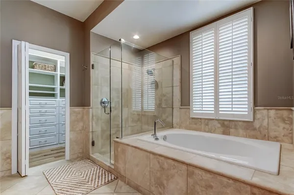a spacious bathroom with a tub shower and a sink