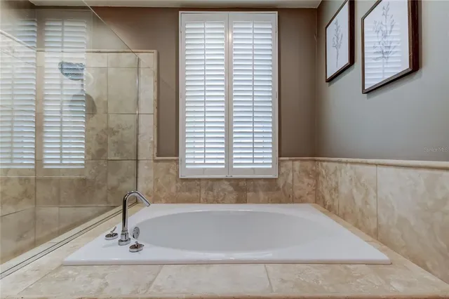 a bathroom with a bathtub and window