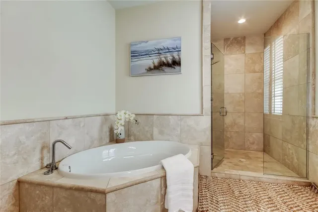 a bathroom with a tub and a shower