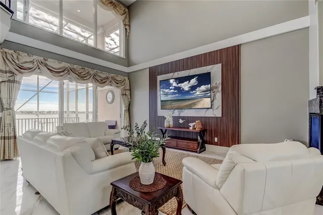 a living room with furniture a chandelier and a painting on the wall