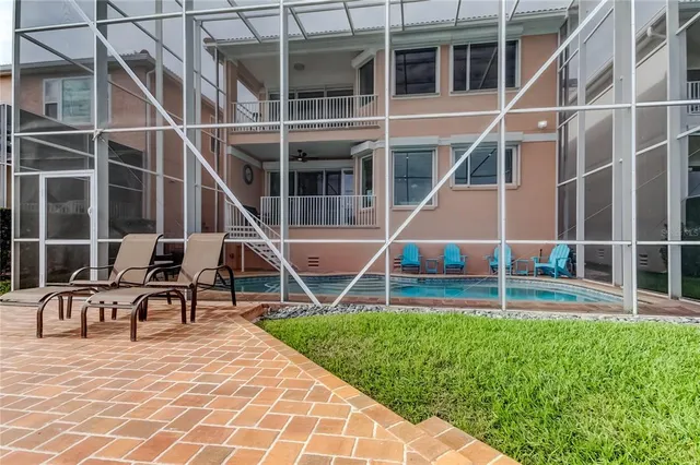 a view of a house with backyard and wooden deck