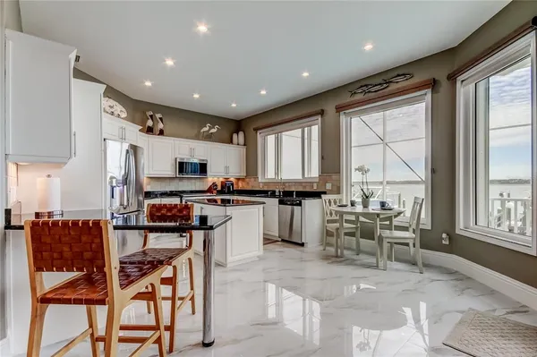 a kitchen with a table chairs refrigerator and cabinets
