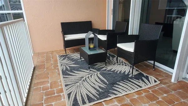 a balcony view with a couch and wooden floor