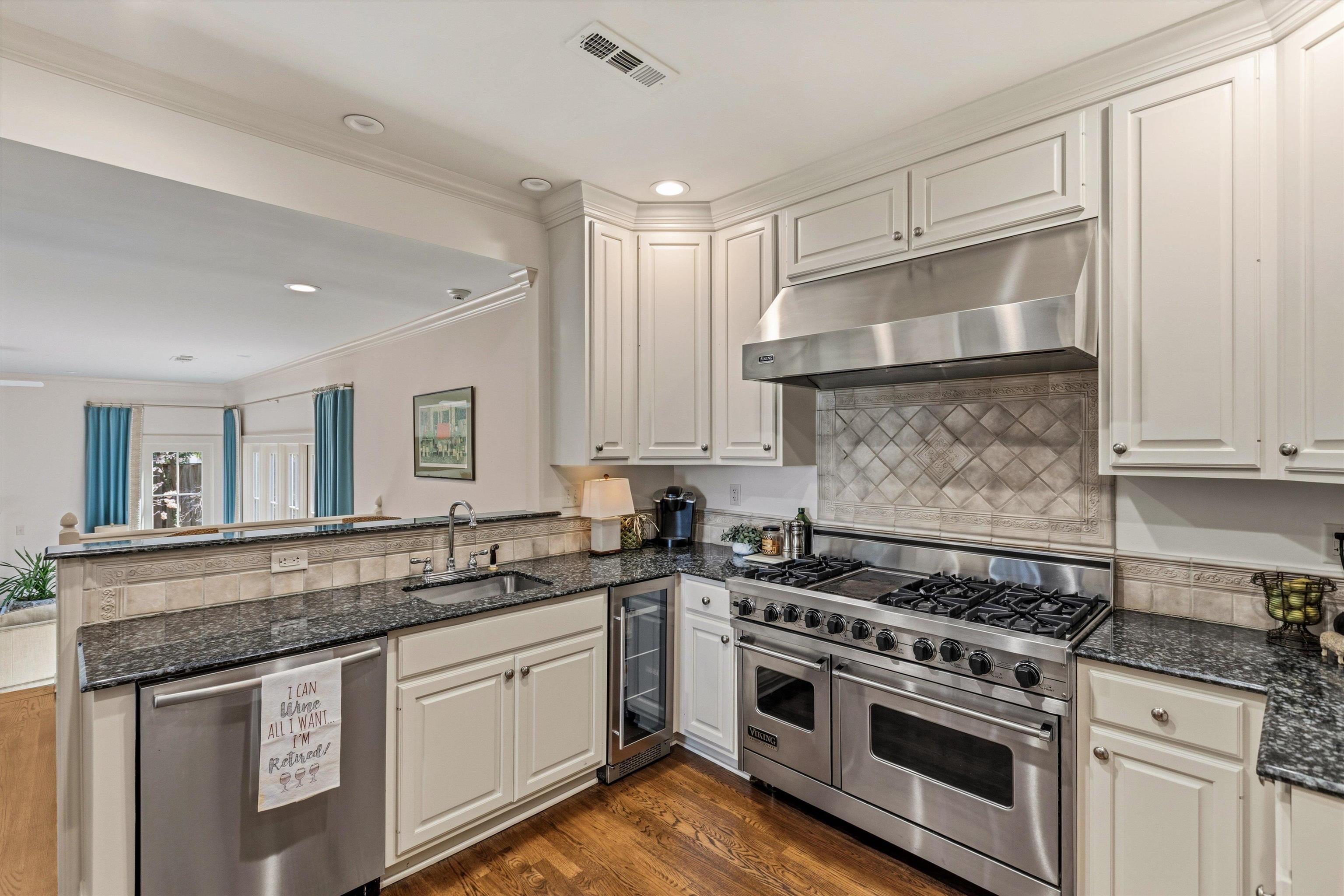 400 Colonial Road Memphis, TN 38117 - Photo 15 of 40 a kitchen with stainless steel appliances granite countertop a stove and white cabinets