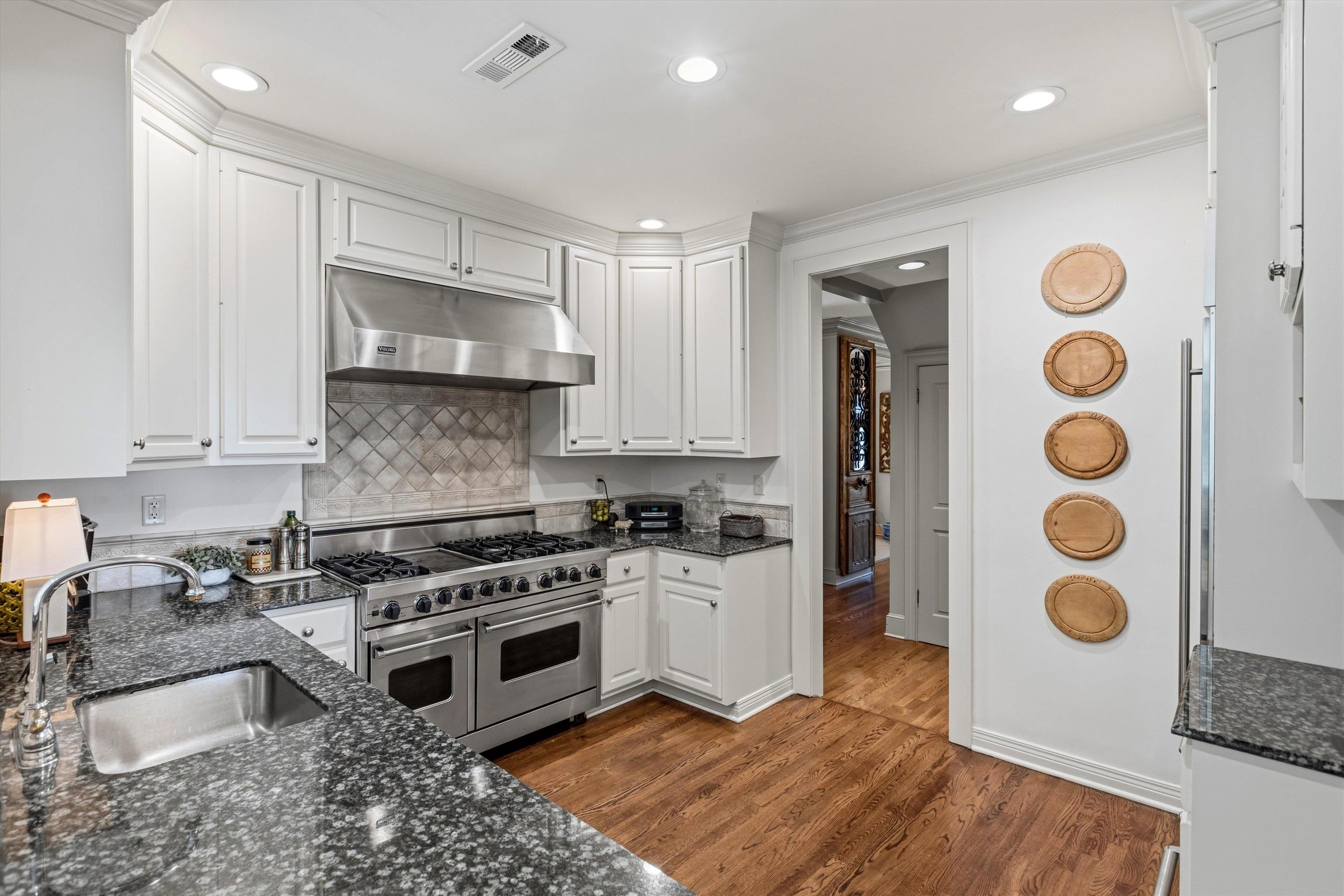 400 Colonial Road Memphis, TN 38117 - Photo 17 of 40 a kitchen with stainless steel appliances granite countertop a stove a sink and a microwave