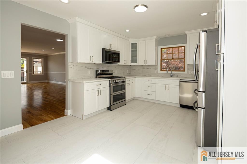 278 Rector Street Perth Amboy, NJ 08861 - Photo 8 of 47 a kitchen with white cabinets and sink