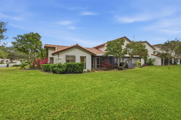 a front view of house with yard and green space