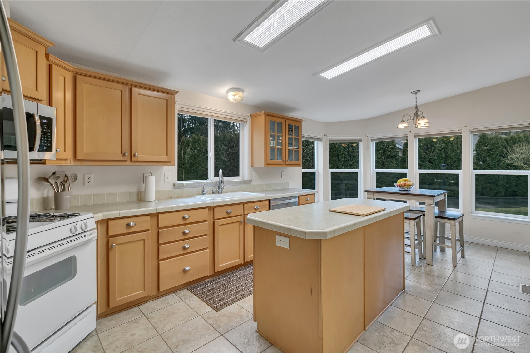 24319 68th Street East, Unit 84 Buckley, WA 98321 - Photo 11 of 40 a kitchen with a stove top oven sink and a microwave