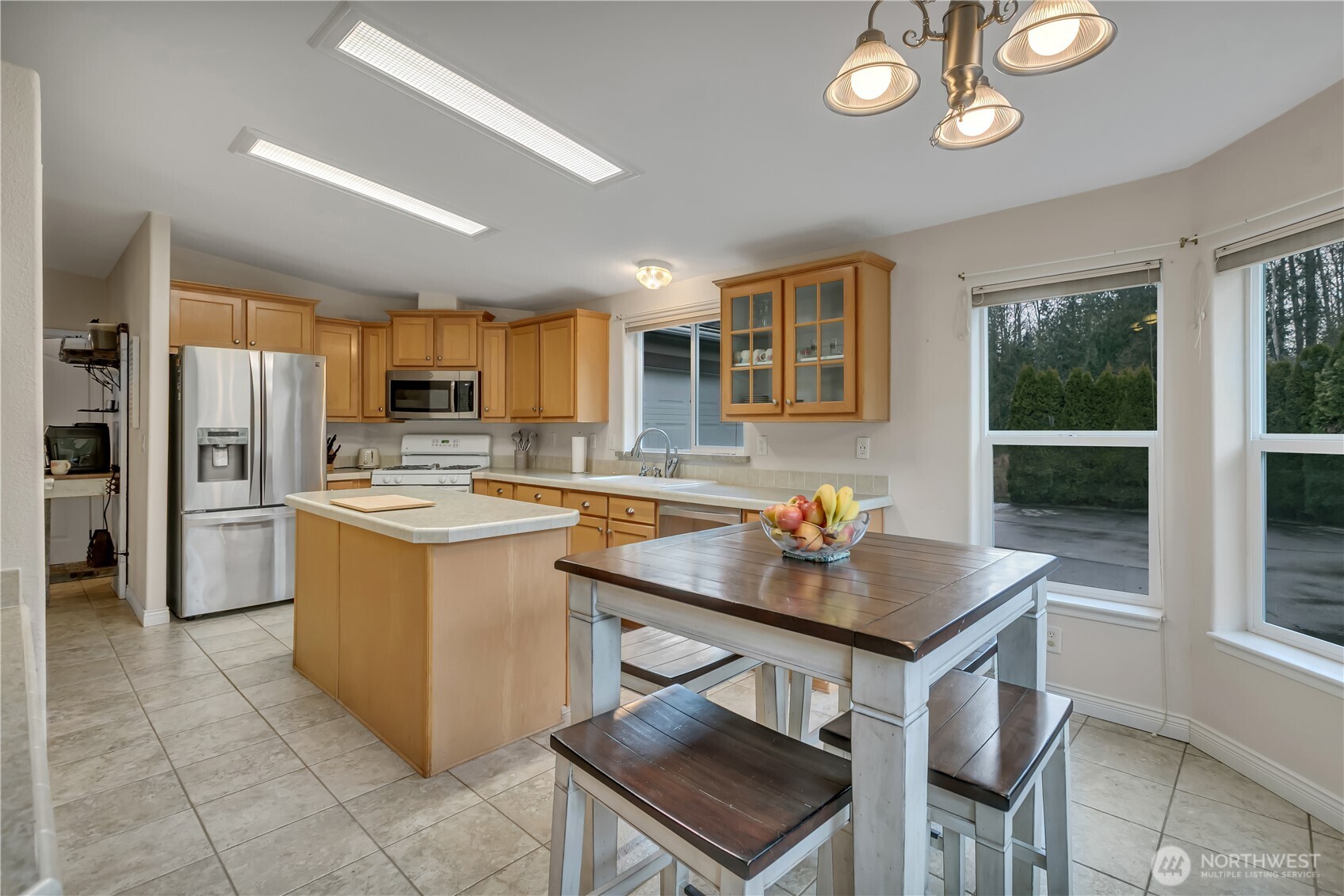 24319 68th Street East, Unit 84 Buckley, WA 98321 - Photo 15 of 40 a kitchen with a stove a refrigerator and a sink