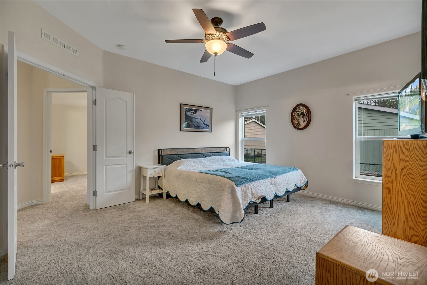 24319 68th Street East, Unit 84 Buckley, WA 98321 - Photo 19 of 40 a spacious bedroom with a bed and a chandelier