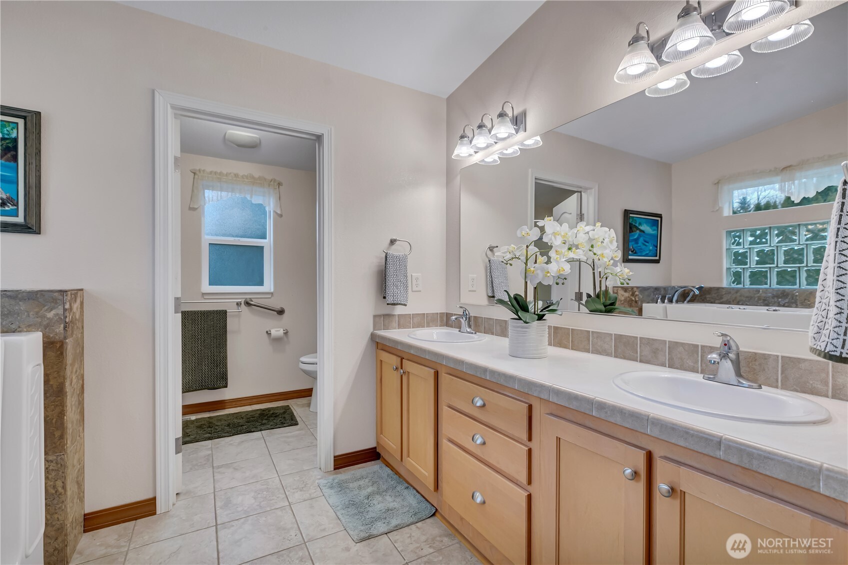 24319 68th Street East, Unit 84 Buckley, WA 98321 - Photo 20 of 40 a spacious en suite bathroom with double sink and a mirror