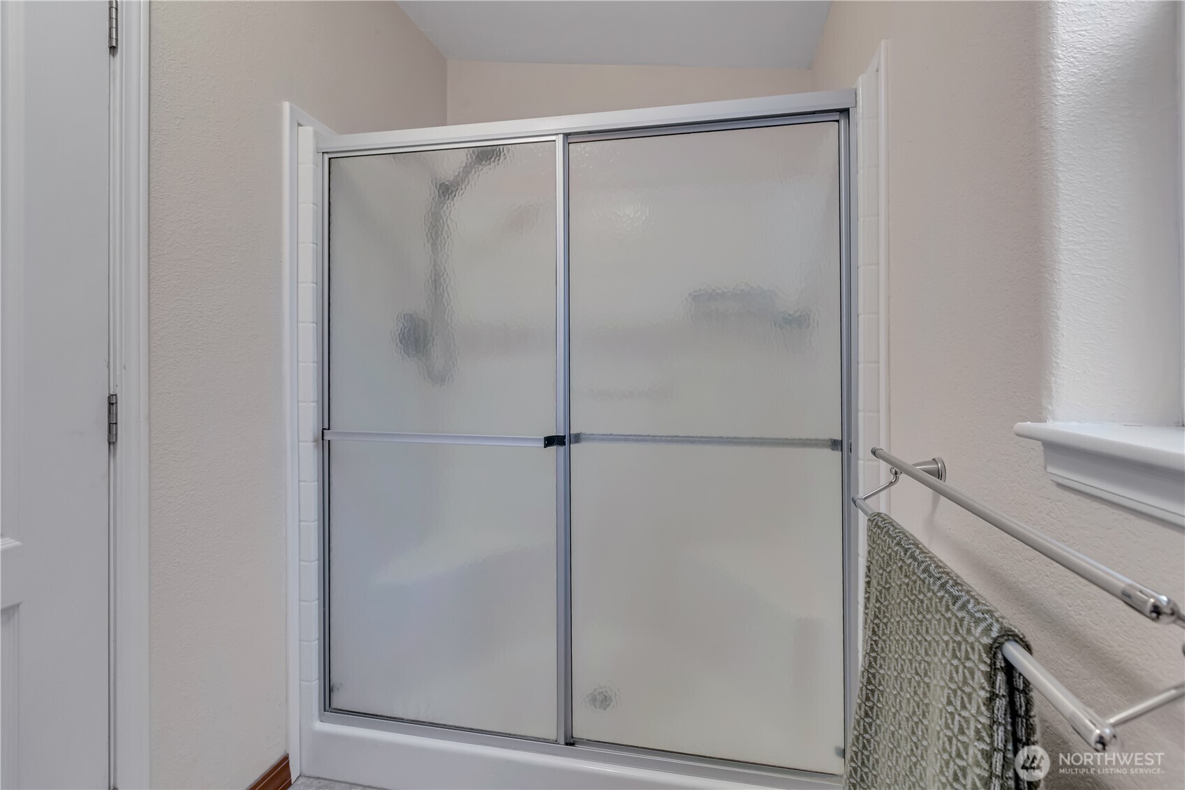 24319 68th Street East, Unit 84 Buckley, WA 98321 - Photo 23 of 40 a bathroom with a glass shower door