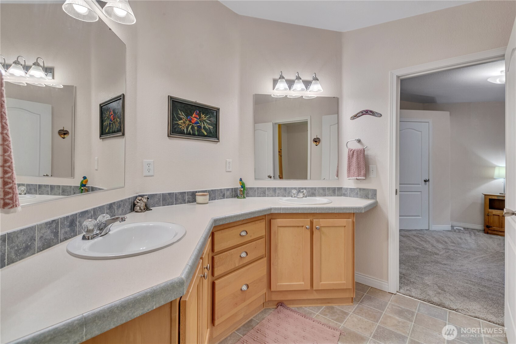 24319 68th Street East, Unit 84 Buckley, WA 98321 - Photo 26 of 40 a bathroom with a sink double vanity granite and a mirror