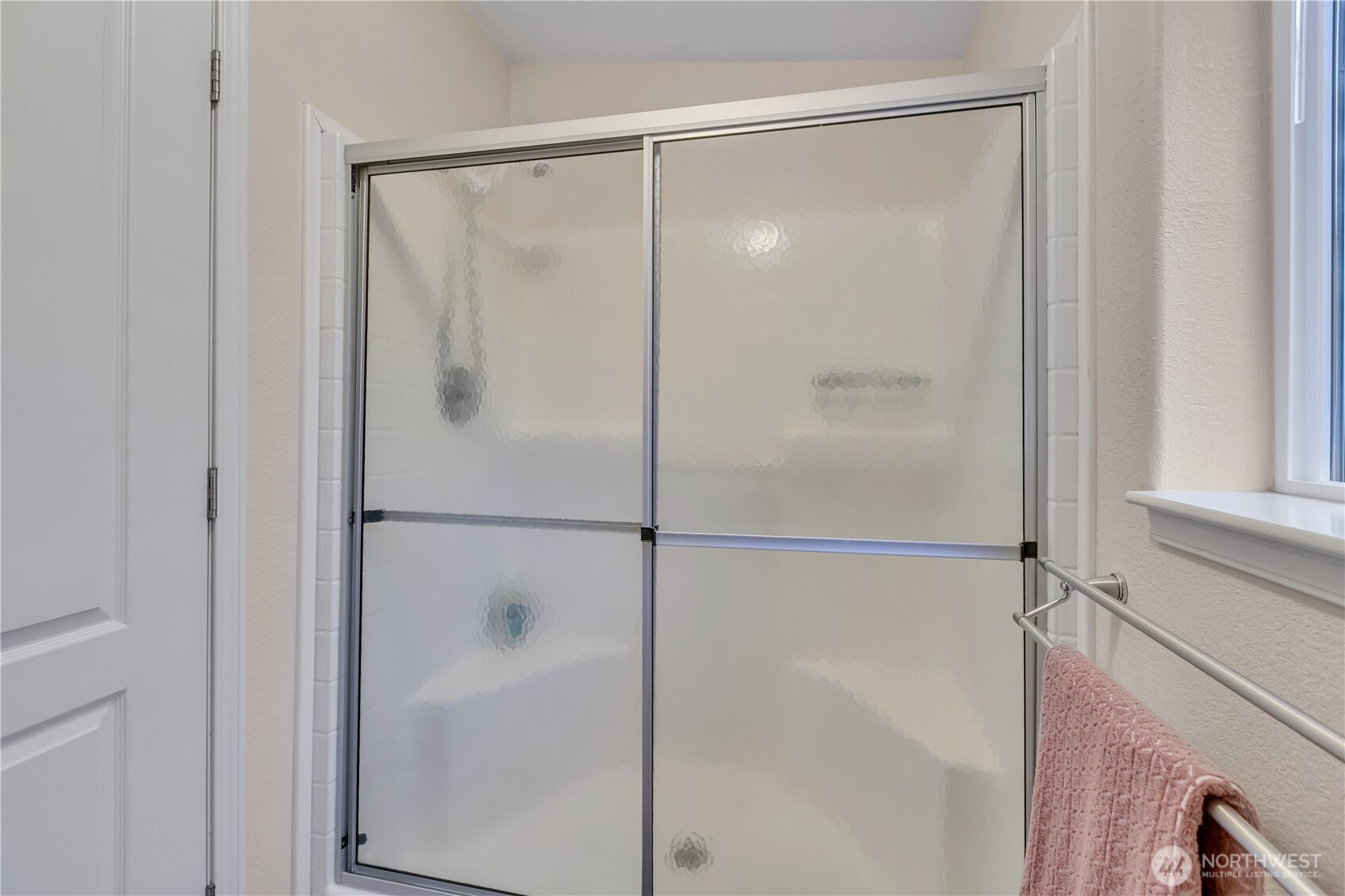 24319 68th Street East, Unit 84 Buckley, WA 98321 - Photo 27 of 40 a bathroom with a glass shower door