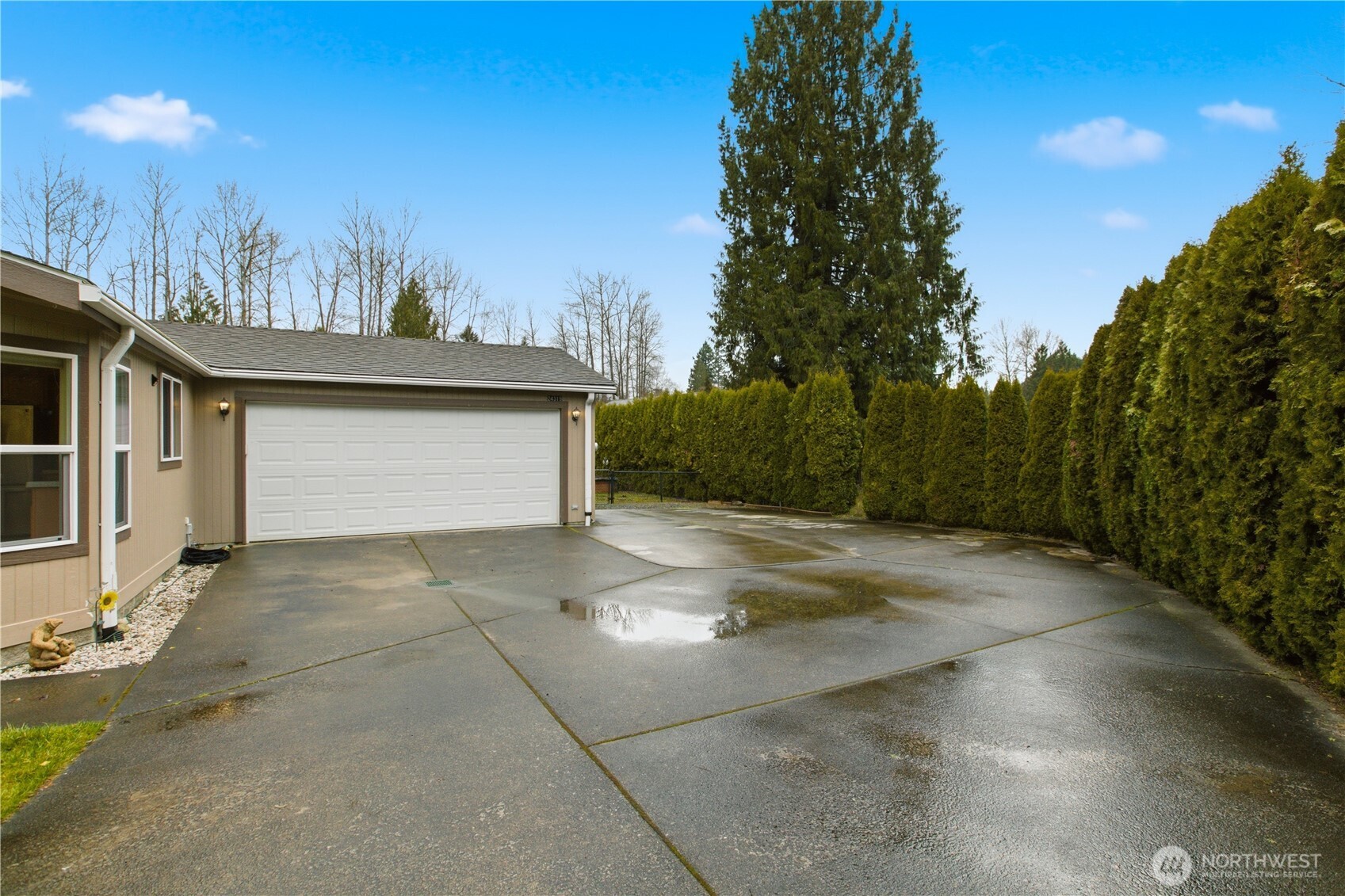 24319 68th Street East, Unit 84 Buckley, WA 98321 - Photo 3 of 40 a view of a parking space in a yard