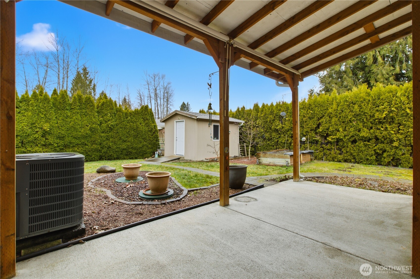 24319 68th Street East, Unit 84 Buckley, WA 98321 - Photo 31 of 40 a view of a porch with furniture and a yard
