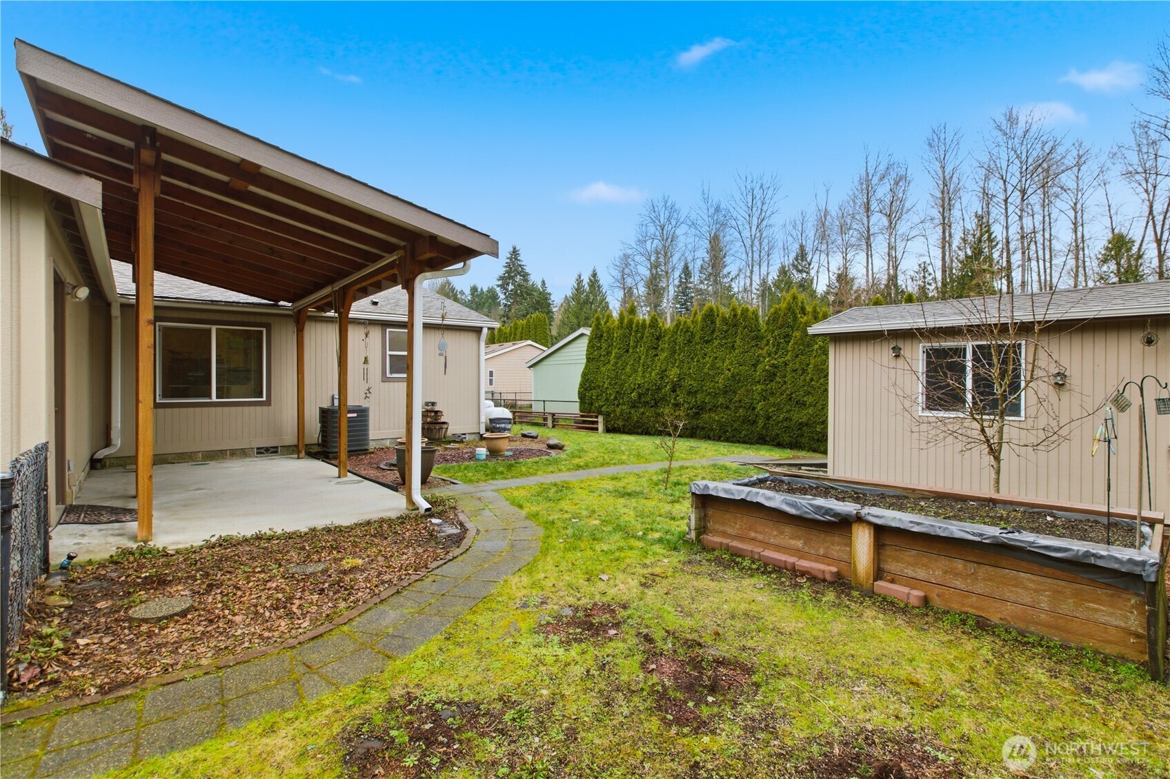 24319 68th Street East, Unit 84 Buckley, WA 98321 - Photo 32 of 40 a view of a house with backyard and sitting area