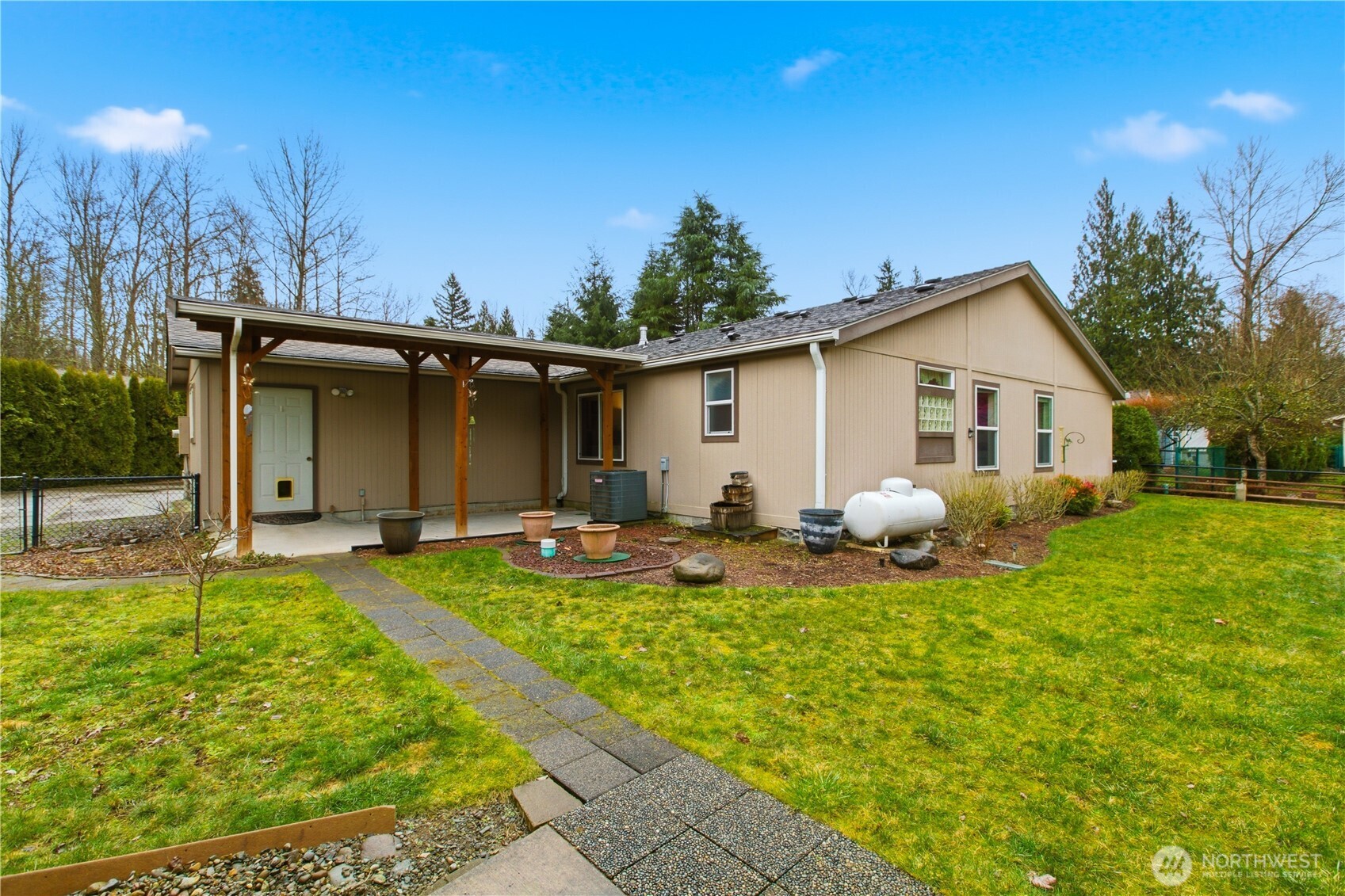 24319 68th Street East, Unit 84 Buckley, WA 98321 - Photo 34 of 40 a view of a house with backyard and sitting area