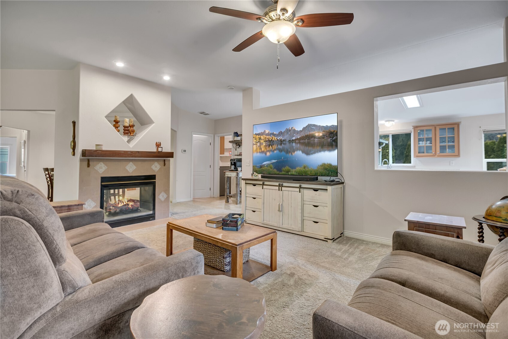 24319 68th Street East, Unit 84 Buckley, WA 98321 - Photo 8 of 40 a living room with furniture a flat screen tv and a fireplace