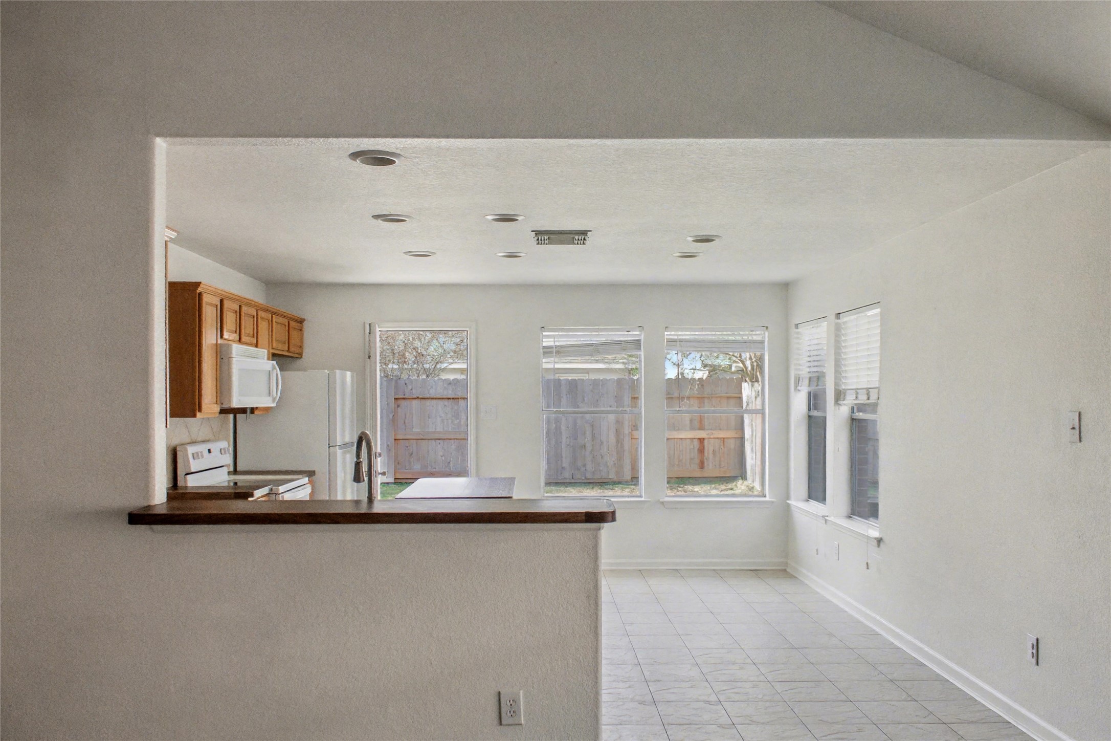 3314 Falcon Trail Drive Spring, TX 77373 - Photo 3 of 10 a view of a kitchen with granite countertop a refrigerator and cabinets