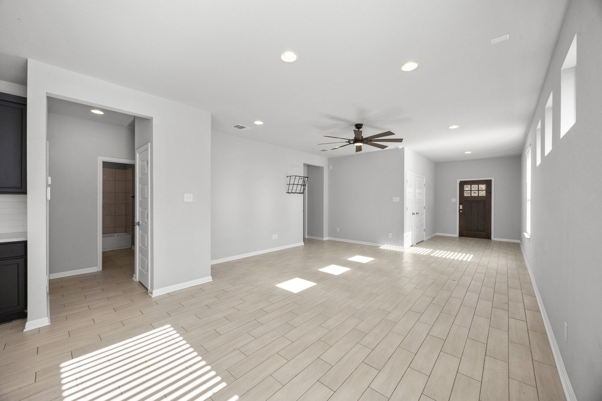 225 Unforgiven Lane Jarrell, TX 76537 - Photo 7 of 30 Unfurnished living room featuring a ceiling fan, recessed lighting, and wood tiled floors