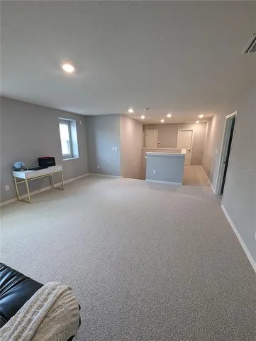 a view of a livingroom with furniture and stairs