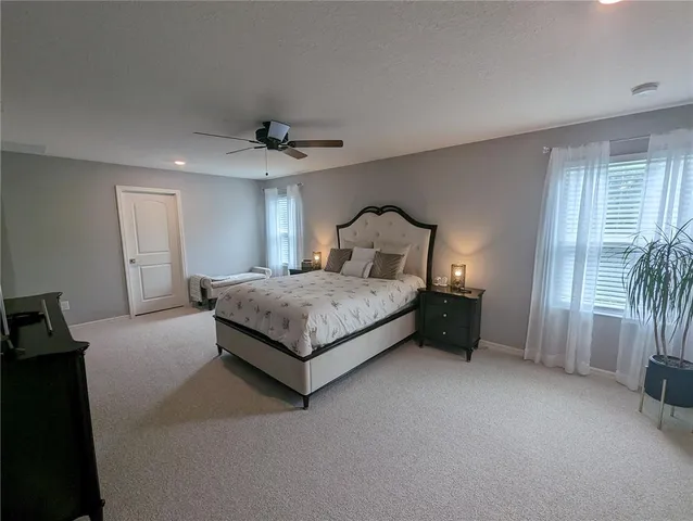 a bedroom with a bed and a view of livingroom