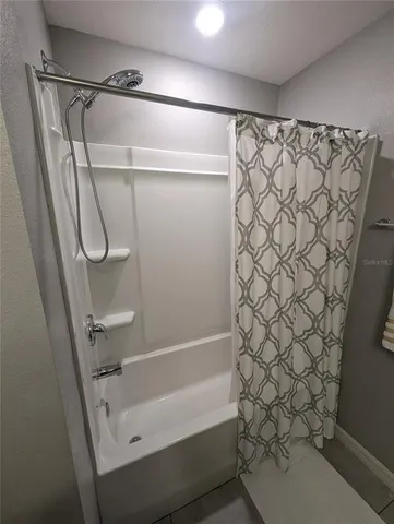 a bathroom with a shower curtain and a sink