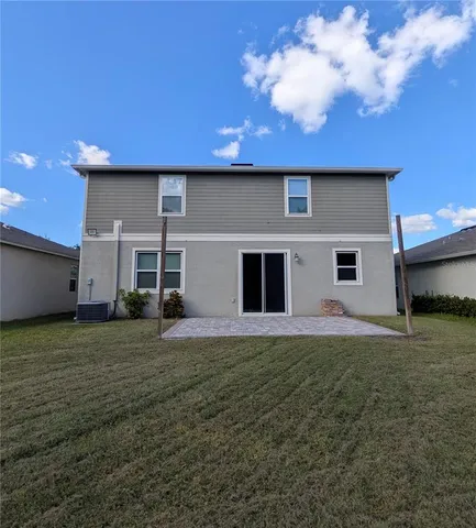 a house that has a big yard large trees with a big yard