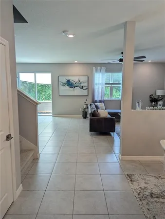 a living room with furniture kitchen and a chandelier