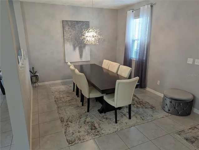 a view of a dining room with furniture and chandelier